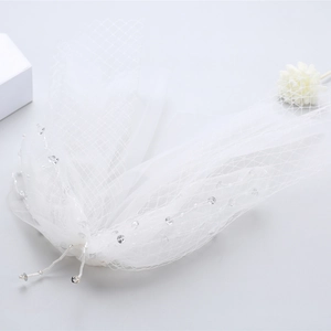 Elegant short white bridal veil with delicate crystal beads and layered tulle bow accessory