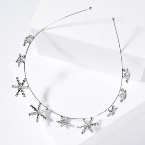 Silver bridal headband featuring textured metallic stars on a white geometric prop
