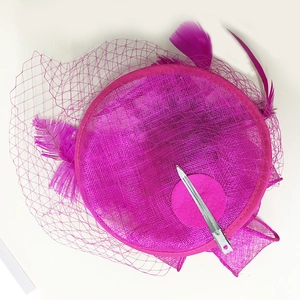 Hot pink fascinator hat with elegant ostrich feathers and mesh veil for party wedding events