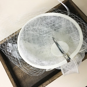 Elegant white fascinator hat with ostrich feathers and mesh veil for formal events