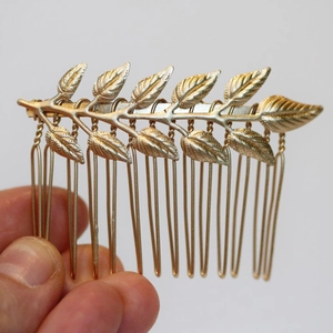 Elegant gold leaf bridal hair comb with vintage metallic foliage for wedding hairstyles
