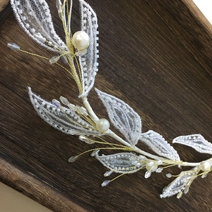 Handmade bridal hair vine with white lace leaves and pearls on golden wire