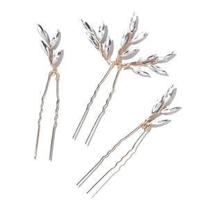 Three-piece bridal hairpin set with champagne gold crystal leaves on a white background