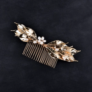 Exquisite bridal hair comb with golden metal leaves and white pearls for wedding hairstyles