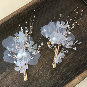 Handmade white floral bridal hair clips with pearls and gold wire for weddings