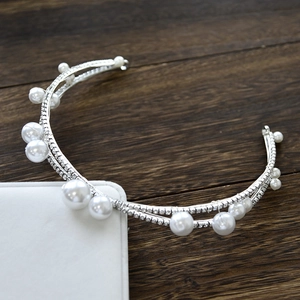 Detail of silver bridal headband featuring double layers with white pearls and crystals
