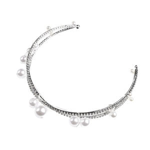 Macro detail of bridal silver headband with inlaid white rhinestones and pearls