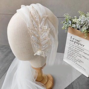 Elegant white bridal veil with leaf embroidery, sequins, and pearls for a vintage look