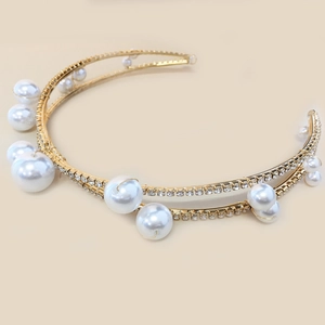Detailed view of a gold double-layered bridal headband with pearls and rhinestones