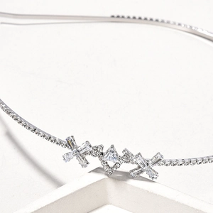 Elegant silver bridal headband with pearl and crystal geometric patterns on white stand