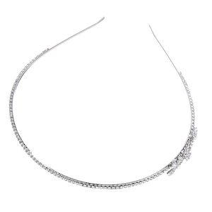 Elegant silver bridal headband with pearls, rhinestones, and side flower cluster detail