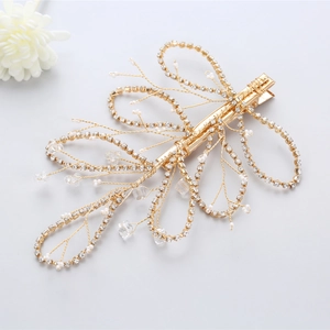 Detail of bridal gold hair clip with handmade pearls and sparkling rhinestones