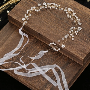 Elegant handmade pearl and crystal wedding hairpiece with white chiffon ribbons