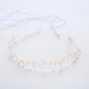 Detail of bridal hair vine with gold wire, pearls, crystals and white silk ribbon
