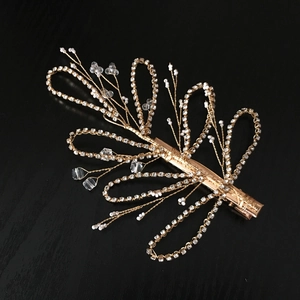 Golden bridal hair clip with white pearls and sparkling crystal flowers for wedding hair