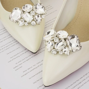 Elegant cream pointed-toe pumps featuring luxurious crystal rhinestone shoe ornaments