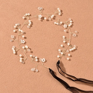 Detailed shot of handmade pearl and crystal hair vine with elegant black chiffon ribbons