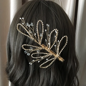 Elegant gold flower hair clip with pearls and crystals for wedding hairstyle