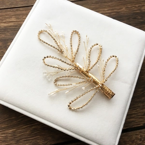 Golden bridal hair pin with handmade pearl flowers and sparkling rhinestone leaves