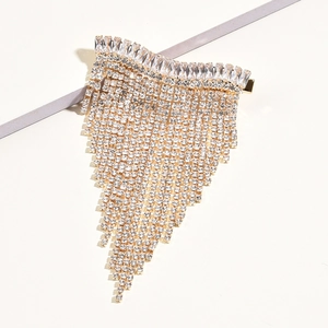 Detail shot of elegant gold hair clip with colorful zircon tassels and fringe rhinestones