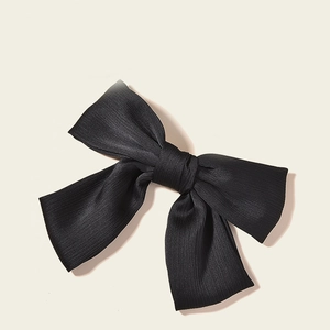 Large black pleated bow hair clip accessory for bridal and wedding ceremonies