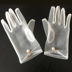 Elegant white sheer tulle bridal gloves with pearl embellishment on black background