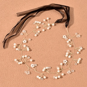 Detail of handmade bridal headband with pearls, crystals and long black chiffon ribbons