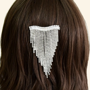 Detail of silver bridal hair clip with shimmering rhinestone fringe on brunette hair