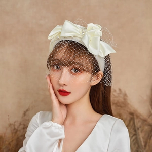 Elegant white satin pearl headband with delicate mesh veil for bridal wedding hair styling