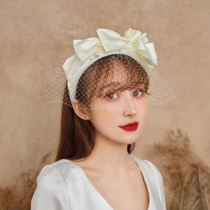 Elegant white satin headband with pearl bow and mesh veil for bridal wedding photography