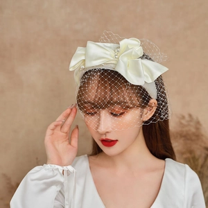 Elegant white satin bridal headband with pearls and vintage birdcage mesh veil