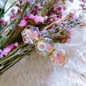 Handmade resin hair clip with pink dried petals, gold foil, and pearls in hexagons