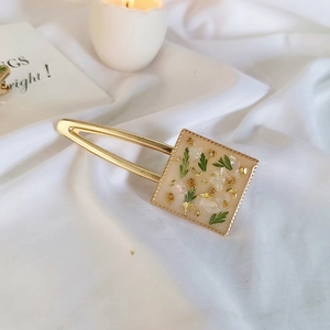 Handmade cream resin hair clip with real green flowers and gold foil in square design