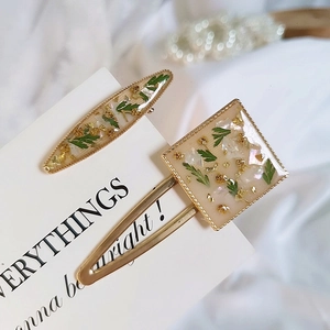 Handmade milky white hair clips with real green dried flowers and gold leaf details