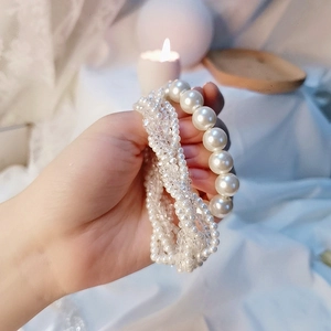 Elegant Korean style pearl and crystal hair ties and bracelet set in soft warm lighting