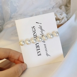 Close-up of elegant Korean style hair clip featuring eight lustrous white imitation pearls