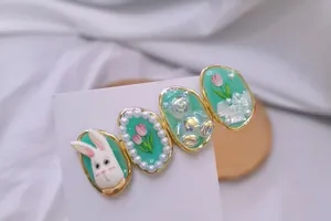 Détail de barrettes vert menthe avec tulipes en perles, petits ours et lapins