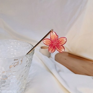 Japanese style gold hair pin with pink cherry blossom relief on a glass edge