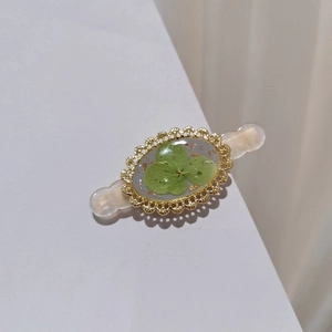 Vintage forest style hair clip with real green clover specimen and gold lace metal frame