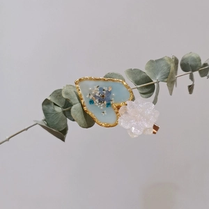 Handmade resin hair clip with blue dried flowers and white glitter flower details