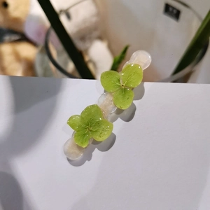 Handmade forest style green hydrangea petal resin hair clip with subtle glitter effect