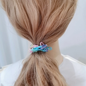 Detail of multi-color braided elastic hair tie shown on model for high ponytail styling