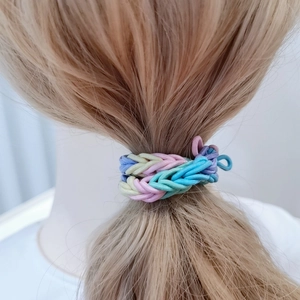 Thick colorful braided elastic bracelet set in macaron shades worn by a model