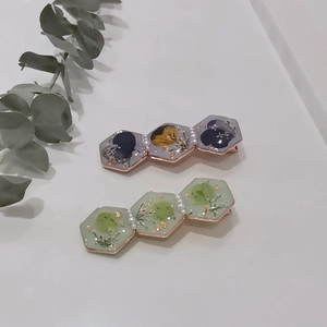 Handmade resin hair clips with dried flowers and gold leaf in hexagonal frames
