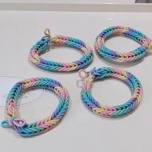 Set of four colorful macaron woven rainbow elastic bracelets with fishtail braid style