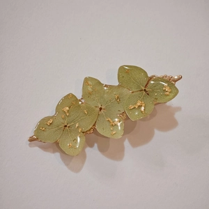 Handmade clear resin hair clip with real green hydrangea petals and gold foil flakes