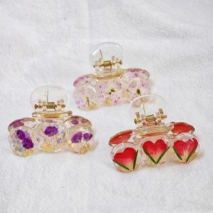Handmade clear resin hair clips set with dried flowers and gold metal spring details