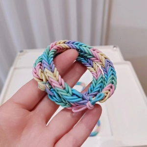 Close-up of thick macaron colored woven hair ties showing elastic spiral braided texture