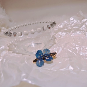 Handmade blue dried flower resin hair clip with gold foil and glitter star effects