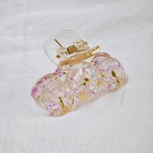 Handmade clear resin shark hair clip with purple dried flowers and glitter details